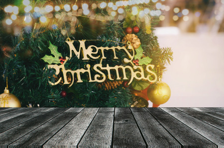 empty modern wooden terrace board or table with christmas tree and light in background, copy space for display of product or object presentation, celebration, christmas holiday, festival conceptの写真素材