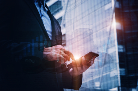 double exposure of investor reading finance information news with mobile tablet, money coin with book bank and graphic candle stick graph chart of stock market investment trading for Forex tradingの写真素材
