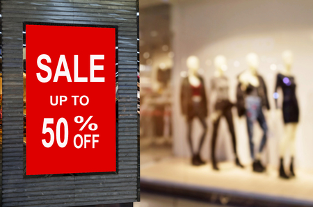 big sale 50% mock up advertise billboard or advertising light box with blurred image of popular fashion clothes shop showcase in department store, commercial, marketing and advertisement conceptの写真素材