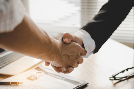 real estate broker manager hand shake with young man customer after signing contract for buying...