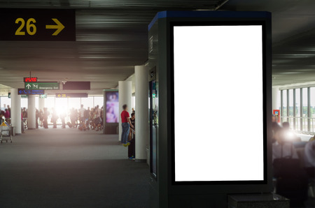 mock up of vertical blank advertising billboard or light box showcase with people waiting at airport, copy space for your text message or media content, advertisement, commercial and marketing conceptの写真素材