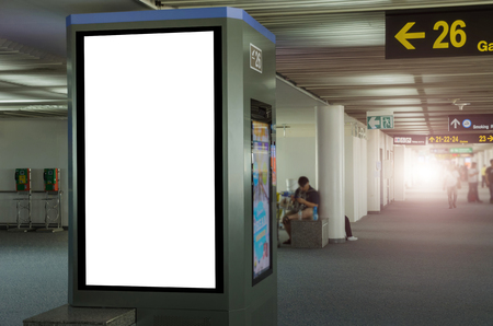 mock up of vertical blank advertising billboard or light box showcase with people waiting at airport, copy space for your text message or media content, advertisement, commercial and marketing conceptの写真素材