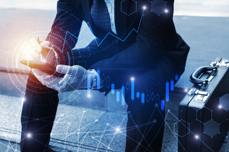 young investor or business man using mobile phone with graphic global network connection and graph chart of stock market investment trading for Forex trading, investment and digital technology conceptの写真素材