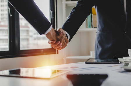 Partnership - group of business people handshake after finishing up business meeting in meeting room office, congratulation, investor, success, partnership, teamwork, financial and connection conceptの写真素材