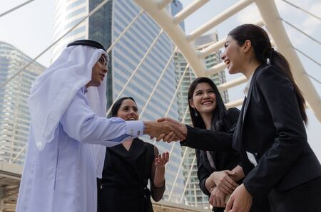 Deal. Welcome. group of Arabian business people handshake after finishing up new project plan business meeting in modern city, success, investment, partner, teamwork, community, connection conceptの写真素材