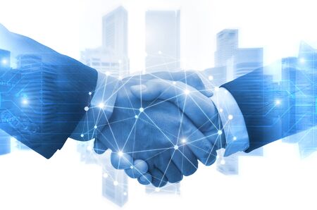 Partnership - business man shaking hands with effect digital network link connection graphic diagram, digital global technology with cityscape background, internet communication and teamwork conceptの写真素材