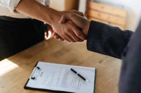 Partnership. two business people shaking hand after business signing contract in meeting room at company office, job interview, investor, success, negotiation, partnership, teamwork, financial conceptの写真素材