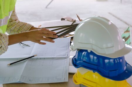 professional architect, engineer or interior design hands working with safety helmet on workplace...
