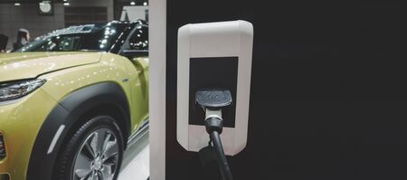 panoramic banner. EV Tech. power supply connect station for electric vehicle battery charge for future, electric car, technology transport industry, power saving, global warming, automobile conceptの写真素材