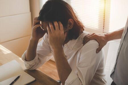 Comforting. asian business man upset about life problems with support from his best friend and...