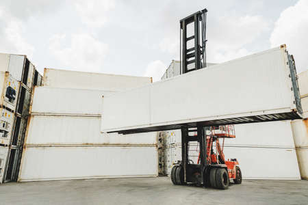 blank white shipping cargo container loading on forklift truck for transportation shipping and logistic at container cargo harbor, industrial, business logistics, import and export business conceptの写真素材