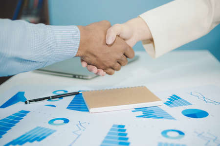 Partnership. two business man investor handshake deal with partner after finishing up business meeting on desk in meeting room office, financial, teamwork, job interview, contract agreement conceptの写真素材