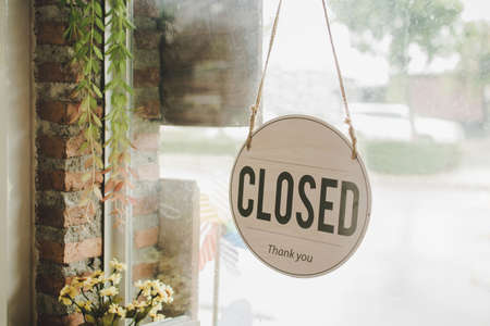 Closed. coffee cafe shop text on vintage sign board hanging on glass door in modern cafe coffee...