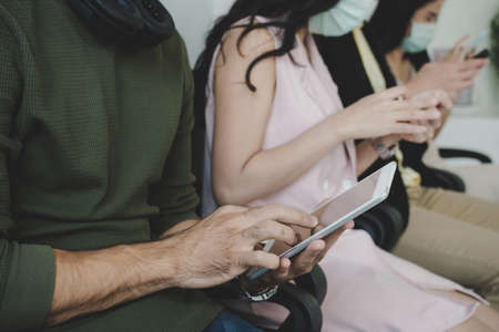 group of business people wearing protective face mask using digital mobile phone connection internet...