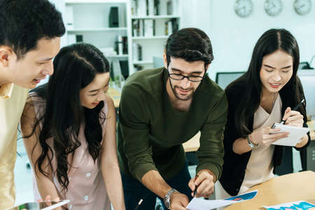 group of colleagues young business people in smart casual working and brainstorm planning new project on desk in meeting room at modern office, digital marketing, business meeting startup conceptの写真素材