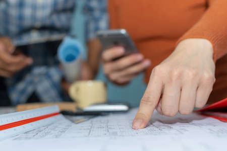 group of colleagues architect or interior designer planning and working on blueprint on desk in meeting room office at construction site, contractor, construction industrial, engineering conceptの写真素材