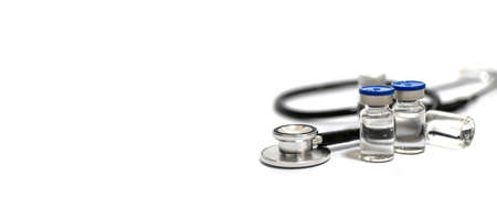 vaccine bottle, stethoscope and medical equipment with copy space on white background, virus prevention, vaccination, medical technology, research laboratory, immunization, covid-19 vaccine conceptの写真素材