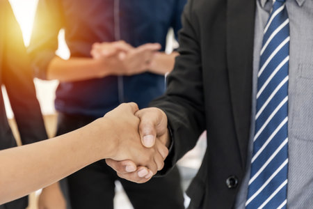Congratulation. happy business people group shaking hand after finishing up business meeting in office, business partnership, negotiation, success, partner, teamwork, community, connection conceptの写真素材
