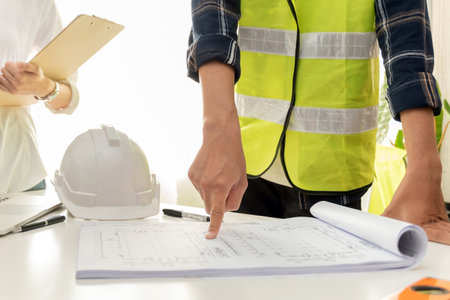 group of architect and engineer construction worker planning and analysing on blueprint in meeting room office at construction site building, industrial, construction contract and contractor conceptの写真素材
