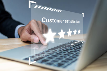 businessman hand touching on digital laptop computer with five star rating to review good feedback...