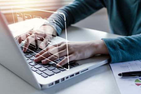people hand using laptop computer with virtual graphic icon on desk at home, document management system, digital marketing, cloud computing, business finance, internet network technology conceptの写真素材