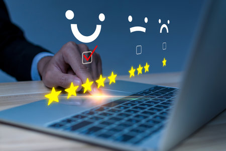 Satisfaction. business people hand touching on laptop computer with virtual graphic five star button to review good rating, digital marketing, good experience, product rating review conceptの写真素材