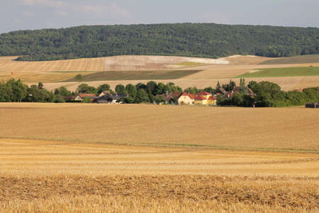 Little countryside village in northern France with harvested wheat fields
の写真素材