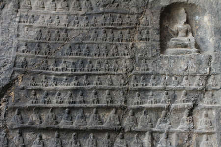 Wall of miniature Buddhas carved in Longmen Grottoes,  in Luoyang, China
の写真素材