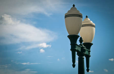 Low angle view of classic lighting pole against blue sky