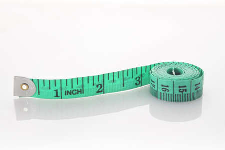 Green  tailor meter on white
