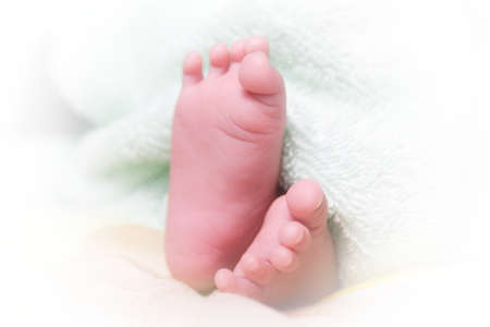 baby new born foot, under the blanketの写真素材