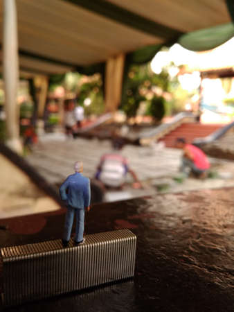businessman supervising his worker installing tiles