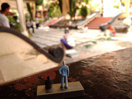 businessman supervising his worker installing tiles