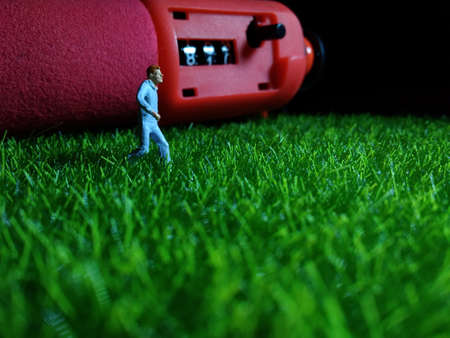 Running Mini Figure man in the night at fresg green grass