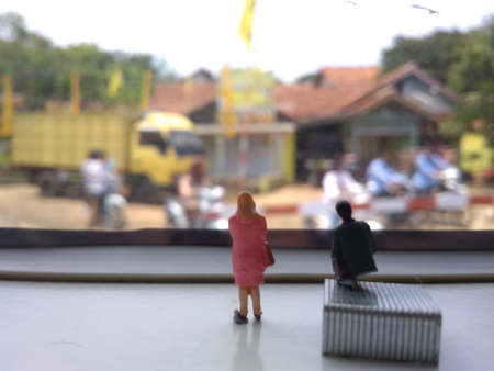 mini figure businessman and businesswoman standing and doing a small discussion at train windowの写真素材