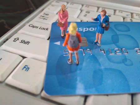 miniature figure bussinesman and bussineswoman discussion about electronic payment at credit card...