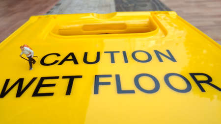 Mini Figure Hiker Walking at Caution Wet Floor Sign