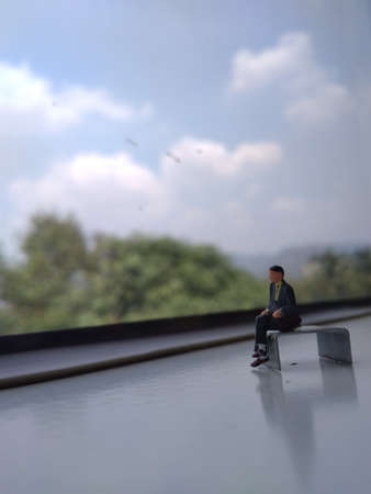 mini figure businessman sit at train window, going to bussines trip