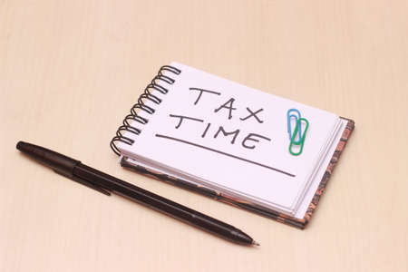 Illustration for Tax Time, block note at wooden tableの写真素材