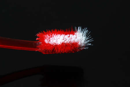 Close Up Used and Damage Red Tooth Brush and black Background