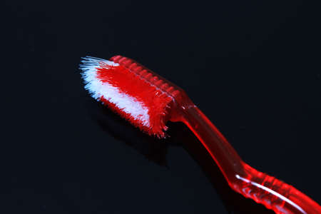 Close Up Used and Damage Red Tooth Brush and black Background