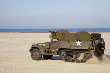 IJMUIDEN, THE NETHERLANDS-MAY 5: Army halftrack of organization Kelly's Heroes riding on beach on May 5,2011 in IJmuiden, The Netherlands. Simulate arrival of allies on liberation Second World Warのeditorial素材