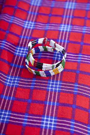 Colorful African bracelet with Masai blanket backgroundの写真素材