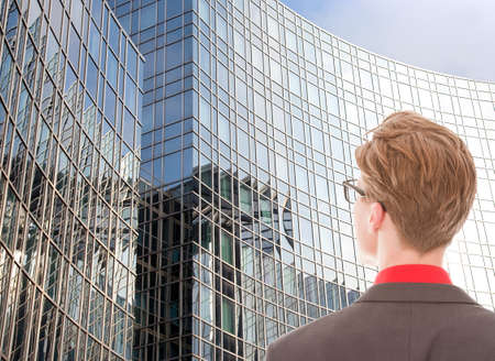 Young man looking at business officeの写真素材