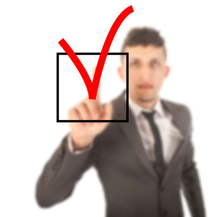 Young businessman with checkbox isolated on white backgroundの写真素材