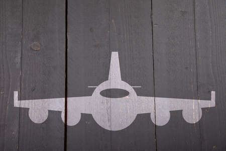 Illustration of white airplane on dark black wooden background