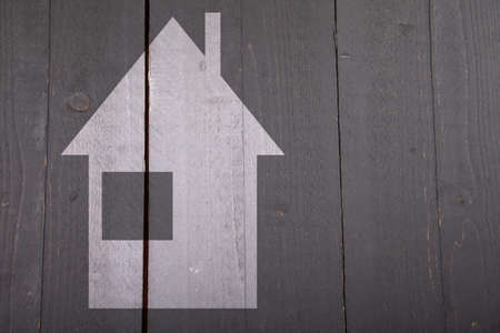 Illustration of white house on dark black wooden backgroundの写真素材