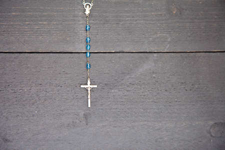 Rosary on dark black wooden backgroundの写真素材