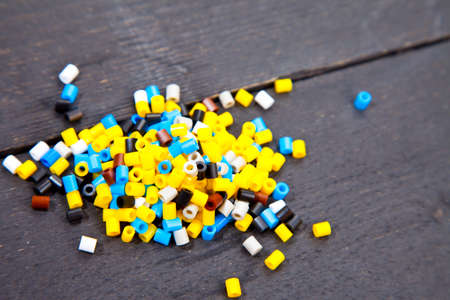 Colorful iron beads on dark black wooden backgroundの写真素材