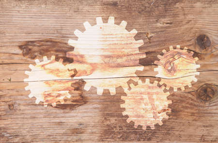 Illustration of gears at brown wooden backgroundの写真素材